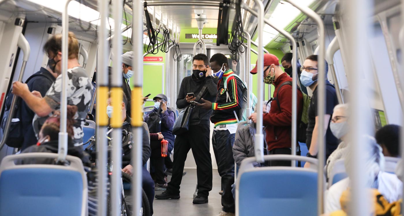 Passengers wearing masks inside of a BART train