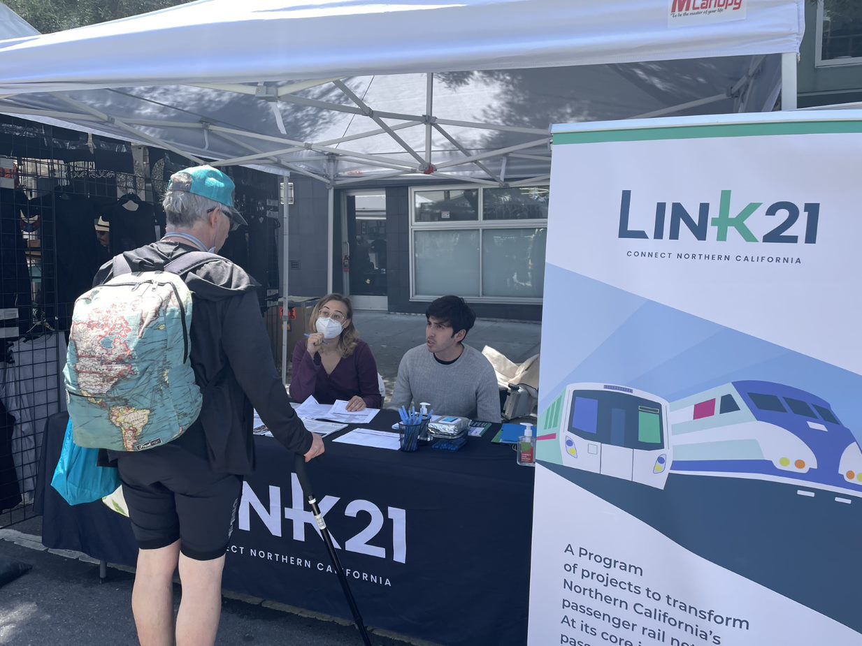 Man talking to Link21 staff at a grassroots event