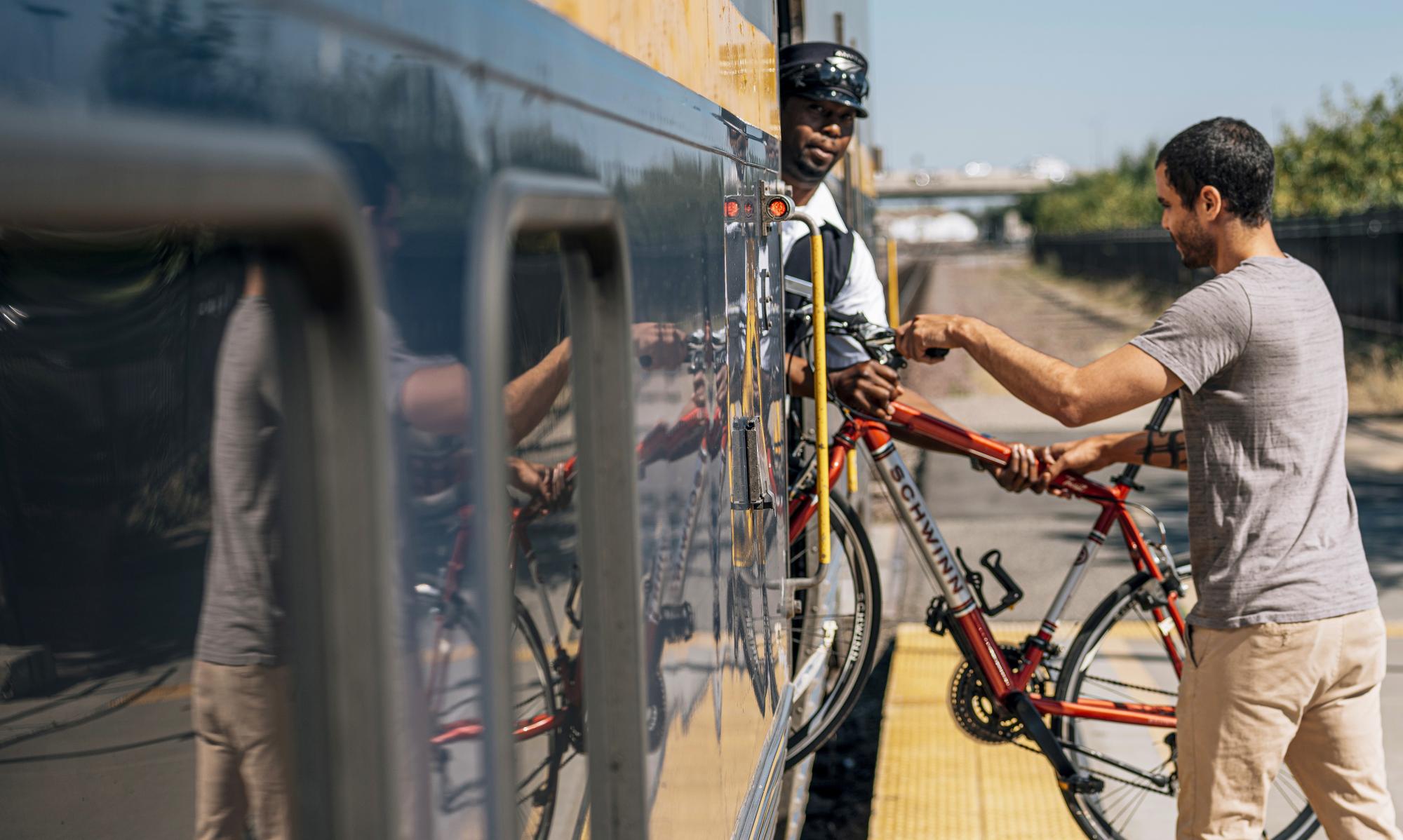 Passenger loading bicycle onto Amtrak train