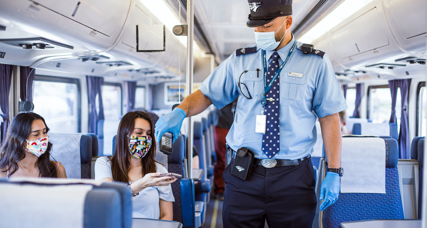 People on a train checking tickets