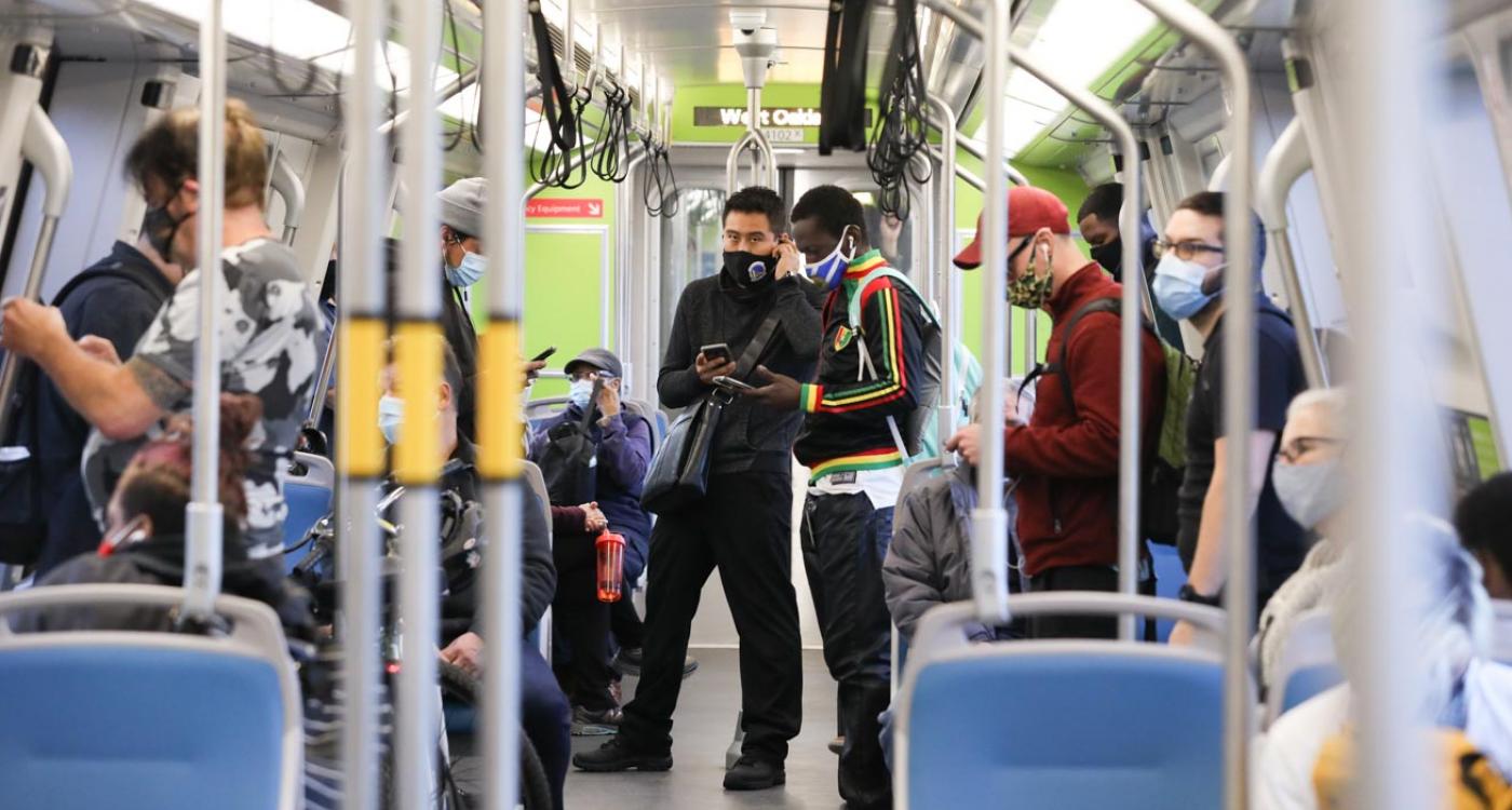 Passengers wearing masks inside of a BART train